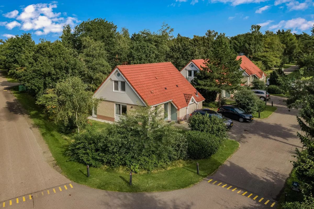 Ferienhaus mit rotem Dach an einer Straße