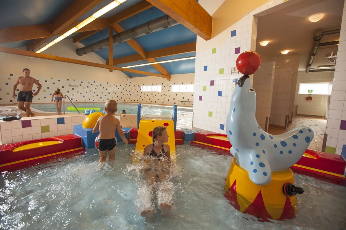 Kinder im Planschbecken mit Wasserspielen