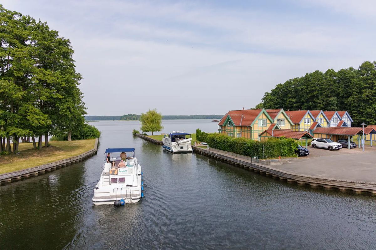 Hausboot fährt durch einen Kanal zum See