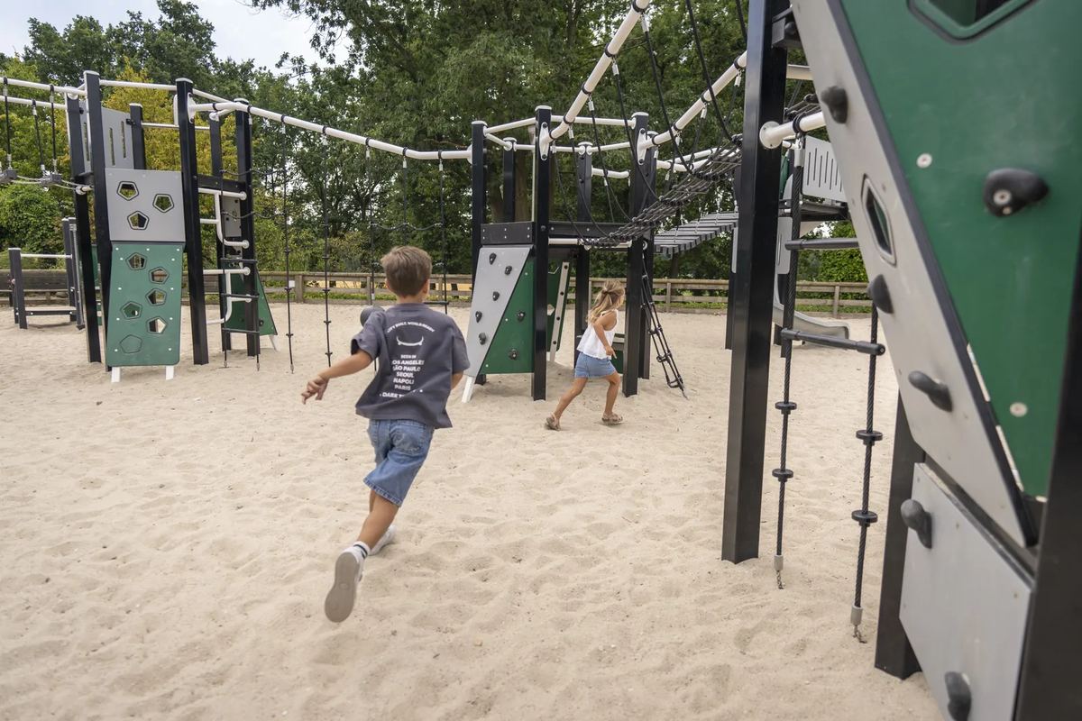 Kinder auf einem Klettergerüst im Sand